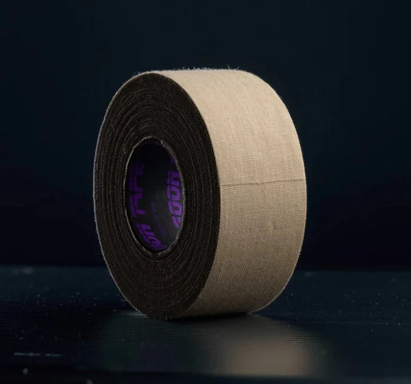 Roll of brown tape with a black border on a dark background